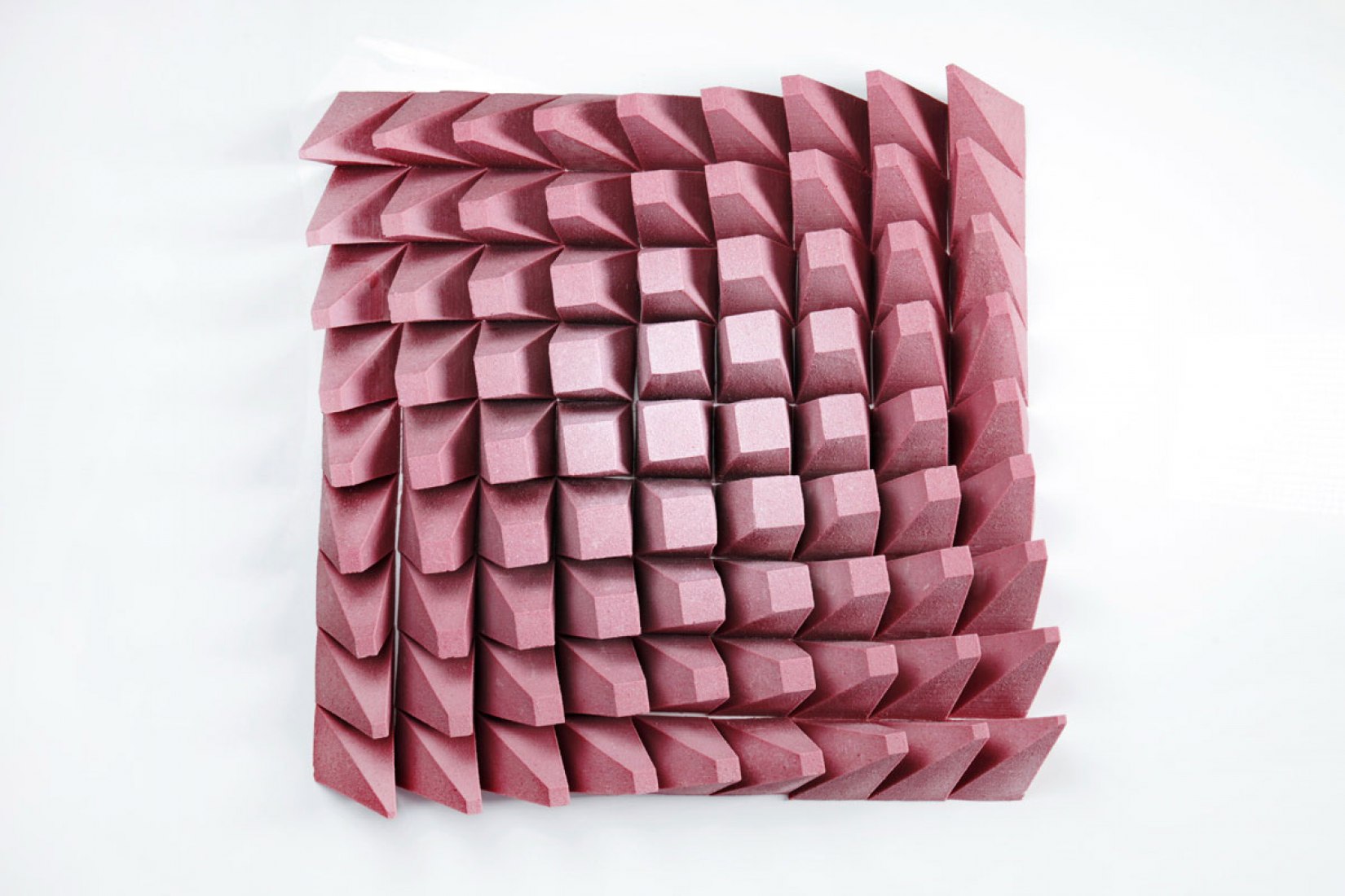 Close-up of the CNC-cut chocolate blade construction — numbered geometric pieces before assembly