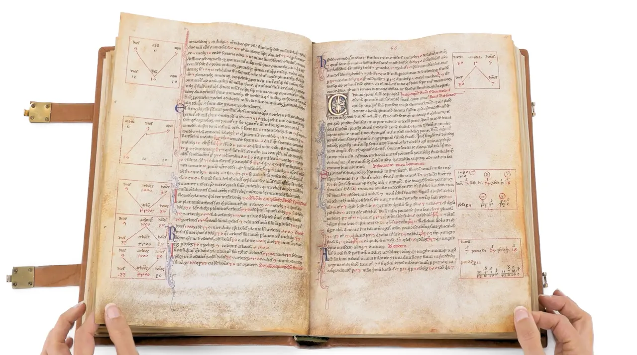 A facsimile of a medieval Liber Abaci manuscript held open by two hands: two pages of dense Latin script with red and blue initials, and ruled boxes in the margins holding worked calculations in Hindu-Arabic numerals